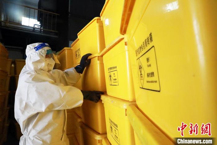 圖為工作人員搬運(yùn)醫(yī)療廢物專用周轉(zhuǎn)箱。　魏建軍 攝