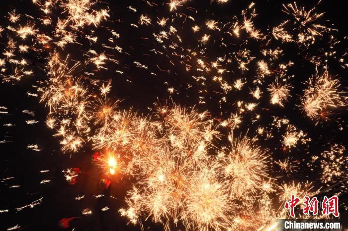 灼熱的鐵水在空中迸散。在空中形成“鐵花火雨”的景象，似天女散花，似群星漫天，如夢如幻，美不勝收。侯奇志 攝</p>
<p>