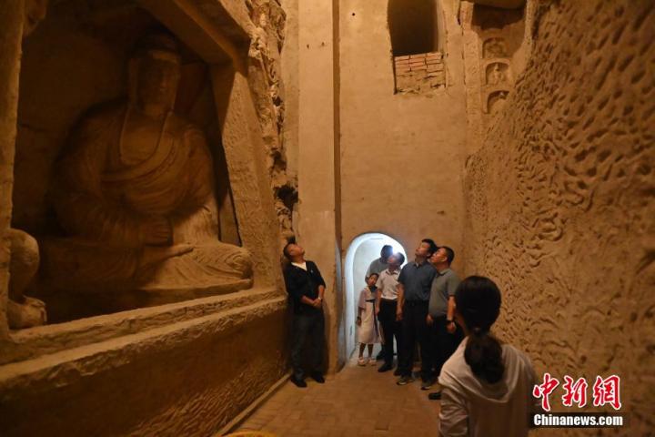 7月15日，游人參觀甘肅省平?jīng)鍪袥艽h百里石窟長廊中的王母宮石窟。百里石窟長廊位于涇川縣境內(nèi)，由512個石窟、5眼窟中石井組成，現(xiàn)存王母宮石窟、鳳凰山石窟、南石窟寺、丈八寺石窟、羅漢洞石窟、太山寺石窟等規(guī)模較大的石窟群，還有數(shù)量眾多的小石窟群。王母宮石窟又名千佛洞，該窟設(shè)計宏大，造像生動，窟內(nèi)擁有造像數(shù)百尊，是較為珍貴的佛教文化歷史遺存。中新社記者 李亞龍 攝</p>
<p>